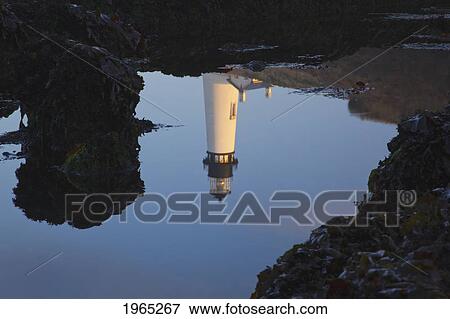 Stock Photo - yaquina head lighthouse reflected in the water; newport oregon united states of america. Fotosearch