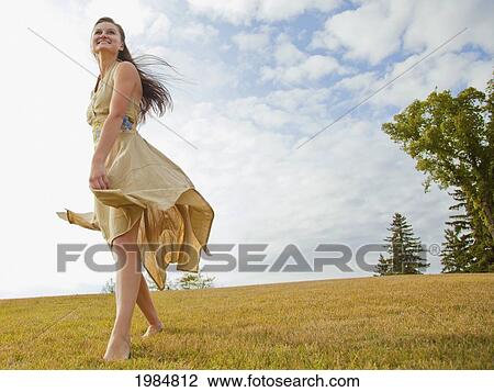 young woman dancing in the park with a flowing dress; edmonton alberta canada View Large Photo Image Stock Image - young woman dancing in the park with a flowing dress; edmonton alberta canada. Fotosearch