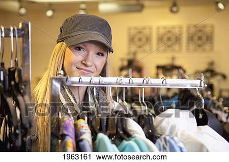 young woman shopping for clothing at a boutique; edmonton, alberta, canada View Large Photo Image Stock Image - young woman shopping for clothing at a boutique; edmonton, alberta, canada. Fotosearch