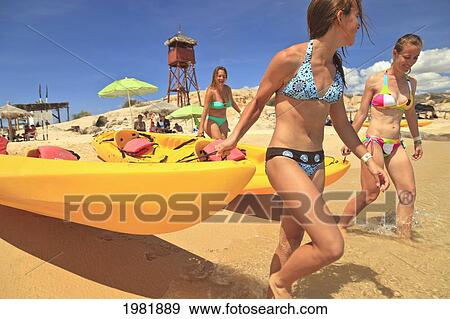 young women pull a boat into the water from the beach at cabo pulmo; baja california sur mexico View Large Photo Image Stock Photo - young women pull a boat into the water from the beach at cabo pulmo; baja california sur mexico. Fotosearch