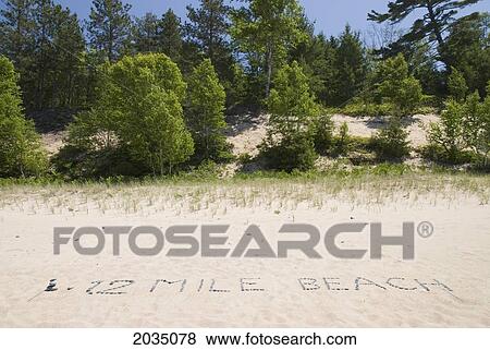 12 mile beach written with rocks in the sand; michigan united states of america View Large Photo Image Stock Photo - 12 mile beach written with rocks in the sand; michigan united states of america. Fotosearch