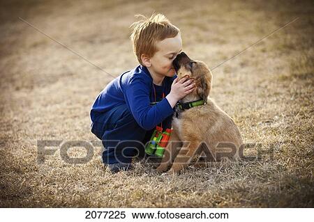 A boys shows affection to his pet dog; spruce grove alberta canada View Large Photo Image Stock Photography - A boys shows affection to his pet dog; spruce grove alberta canada. Fotosearch