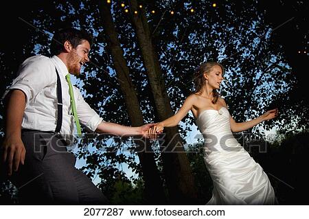 A bride and groom dancing at dusk on an illuminated dance floor; vancouver british columbia canada View Large Photo Image Stock Photo - A bride and groom dancing at dusk on an illuminated dance floor; vancouver british columbia canada. Fotosearch