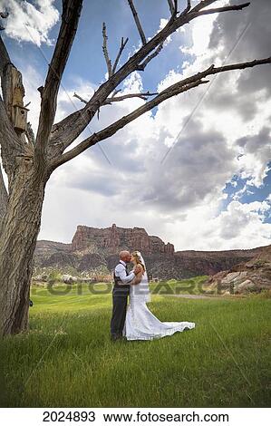 A Bride And Groom Kiss In High Desert; Grand Junction Colorado United States Of America View Large Photo Image Stock Image - A Bride And Groom Kiss In High Desert; Grand Junction Colorado United States Of America. Fotosearch
