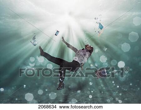 Picture - A Businesswoman Floating Underwater With Her Laptop Computer Cell Phone And Shoes; Cadiz Spain. Fotosearch