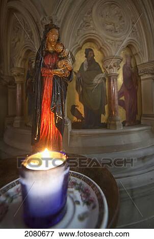 A candle burns beside a small sculpture of a woman holding a baby in st. andrew's church; kelso scottish borders scotland View Large Photo Image Stock Photo - A candle burns beside a small sculpture of a woman holding a baby in st. andrew's church; kelso scottish borders scotland. Fotosearch