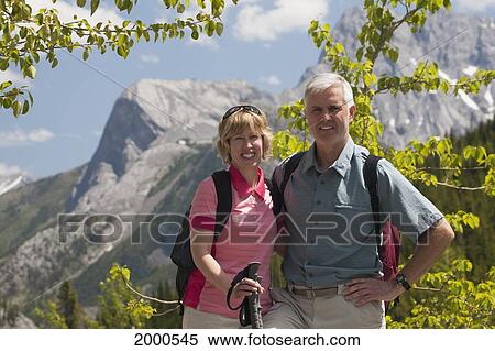 A Couple Hiking In The Mountain; Alberta Canada View Large Photo Image Stock Photography - A Couple Hiking In The Mountain; Alberta Canada. Fotosearch