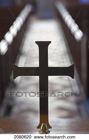 Stock Image - A cross in line with a centre aisle in a church; staindrop durham england. Fotosearch