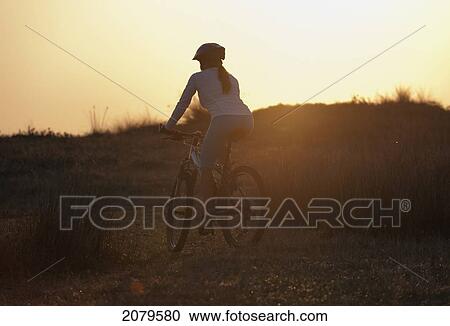 A cyclist rides on a path at sunset; tarifa cadiz andalusia spain View Large Photo Image Stock Image - A cyclist rides on a path at sunset; tarifa cadiz andalusia spain. Fotosearch