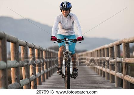 A cyclist rides on a wooden boardwalk; tarifa cadiz andalusia spain View Large Photo Image Stock Image - A cyclist rides on a wooden boardwalk; tarifa cadiz andalusia spain. Fotosearch