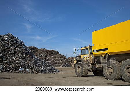 A dump truck sitting beside a pile of debris; south shields tyne and wear england View Large Photo Image Stock Photo - A dump truck sitting beside a pile of debris; south shields tyne and wear england. Fotosearch