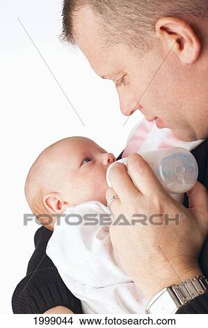 Picture - A Father Feeding A Newborn Baby From A Bottle; Dundas Minnesota United States Of America. Fotosearch