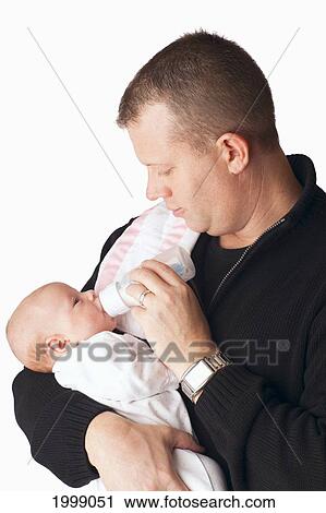 Stock Image - A Father Feeding A Newborn Baby From A Bottle; Dundas Minnesota United States Of America. Fotosearch