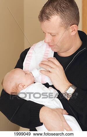 Stock Photo - A Father Feeding A Newborn Baby From A Bottle; Dundas Minnesota United States Of America. Fotosearch