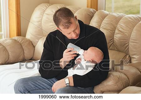 A Father Feeding His Newborn Baby From A Bottle; Dundas Minnesota United States Of America View Large Photo Image Stock Image - A Father Feeding His Newborn Baby From A Bottle; Dundas Minnesota United States Of America. Fotosearch