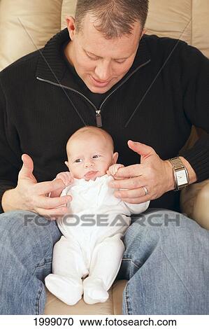 A Father Sits With His Newborn Baby; Dundas Minnesota United States Of America View Large Photo Image Stock Image - A Father Sits With His Newborn Baby; Dundas Minnesota United States Of America. Fotosearch