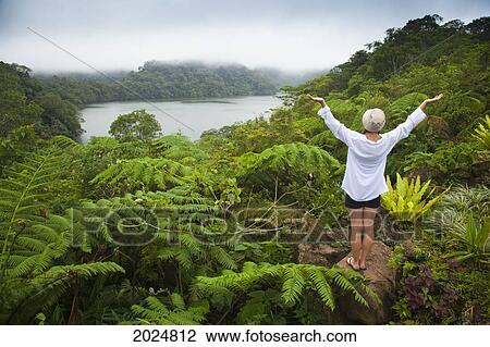 A Female Tourist Stands Among Tropical Plants That Grow Around The Twin Lakes At Twin Lakes National Park; Island Of s Philippines View Large Photo Image Stock Image - A Female Tourist Stands Among Tropical Plants That Grow Around The Twin Lakes At Twin Lakes National Park; Island Of s Philippines. Fotosearch