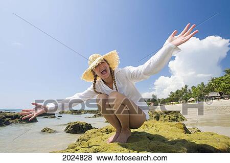 A Female Tourist Stretches Out Her Arms On The Beach Of A Tropical Island; Koh Lanta Krabi Province Thailand View Large Photo Image Stock Photo - A Female Tourist Stretches Out Her Arms On The Beach Of A Tropical Island; Koh Lanta Krabi Province Thailand. Fotosearch