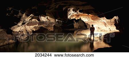 A Filipino Tour Guide Holds A Lantern Inside Sumaging Cave Or Big Cave Near Sagada; Luzon Philippines View Large Photo Image Picture - A Filipino Tour Guide Holds A Lantern Inside Sumaging Cave Or Big Cave Near Sagada; Luzon Philippines. Fotosearch