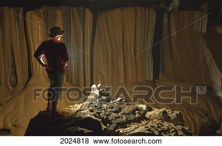 Stock Photo - A Filipino Tour Guide Holds A Lantern Inside Sumaging Cave Or Big Cave; Sagada Luzon Philippines. Fotosearch