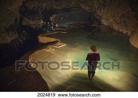 Stock Photo - A Filipino Tour Guide Holds A Lantern Inside Sumaging Cave Or Big Cave; Sagada Luzon Philippines. Fotosearch