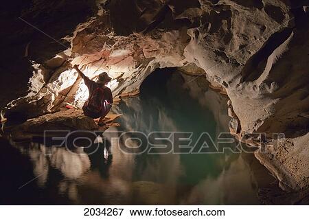 A Filipino Tour Guide Holds A Lantern Inside Sumaging Cave Or Big Cave Near Sagada; Luzon Philippines View Large Photo Image Stock Photo - A Filipino Tour Guide Holds A Lantern Inside Sumaging Cave Or Big Cave Near Sagada; Luzon Philippines. Fotosearch