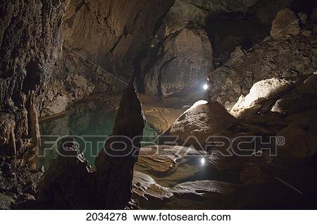 A Filipino Tour Guide Holds A Lantern Inside Sumaging Cave Or Big Cave Near Sagada; Luzon Philippines View Large Photo Image Stock Photo - A Filipino Tour Guide Holds A Lantern Inside Sumaging Cave Or Big Cave Near Sagada; Luzon Philippines. Fotosearch