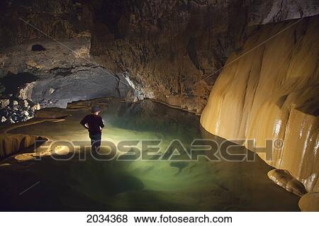 A Filipino Tour Guide Holds A Lantern Inside Sumaging Cave Or Big Cave Near Sagada; Luzon Philippines View Large Photo Image Stock Photo - A Filipino Tour Guide Holds A Lantern Inside Sumaging Cave Or Big Cave Near Sagada; Luzon Philippines. Fotosearch