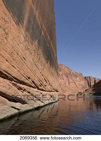 Stock Photograph - A Flat Rock Wall Against The Colorado River; Arizona United States Of America. Fotosearch