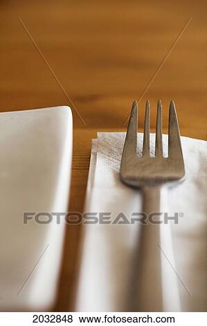 A Fork Placed On A White Serviette Beside A White Plate; Coolangatta Queensland Australia View Large Photo Image Stock Photo - A Fork Placed On A White Serviette Beside A White Plate; Coolangatta Queensland Australia. Fotosearch
