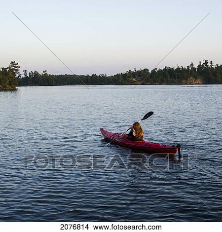 A girl in a kayak; lake of the woods ontario canada View Large Photo Image Picture - A girl in a kayak; lake of the woods ontario canada. Fotosearch