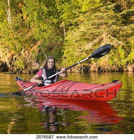 A girl kayaking in the lake; lake of the woods ontario canada View Large Photo Image Stock Photo - A girl kayaking in the lake; lake of the woods ontario canada. Fotosearch