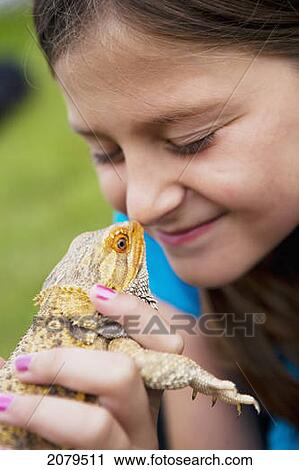 A girl puts a lizard up to her nose; edmonton alberta canada View Large Photo Image Stock Image - A girl puts a lizard up to her nose; edmonton alberta canada. Fotosearch
