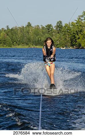 A girl waterskiing; lake of the woods ontario canada View Large Photo Image Picture - A girl waterskiing; lake of the woods ontario canada. Fotosearch