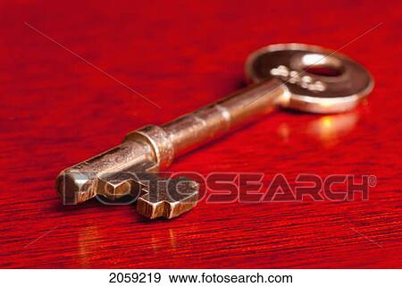 A Gold Key Sitting On A Red Table View Large Photo Image Stock Photo - A Gold Key Sitting On A Red Table. Fotosearch