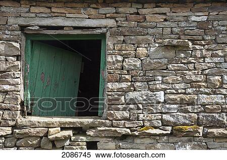 Stock Photography - A green wooden window on a stone wall; swaledale england. Fotosearch