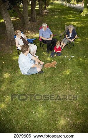 A group of people sit on the lawn visiting; edmonton alberta canada View Large Photo Image Stock Photograph - A group of people sit on the lawn visiting; edmonton alberta canada. Fotosearch