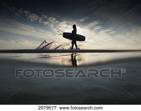 A kitesurfer walks along the beach at sunset; tarifa cadiz andalusia spain View Large Photo Image Stock Photo - A kitesurfer walks along the beach at sunset; tarifa cadiz andalusia spain. Fotosearch