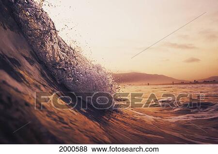Stock Photo - A Large Wave In The Ocean At Sunset; Tarifa Cadiz Andalusia Spain. Fotosearch