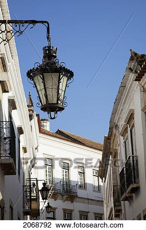 Stock Image - A Light Mounted To The Side Of A Building; Faro Algarve Portugal. Fotosearch