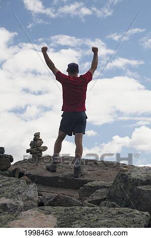 A Male Hiker On Top Of A Mountain With A Cairn; Lake Louise Alberta Canada View Large Photo Image Stock Image - A Male Hiker On Top Of A Mountain With A Cairn; Lake Louise Alberta Canada. Fotosearch