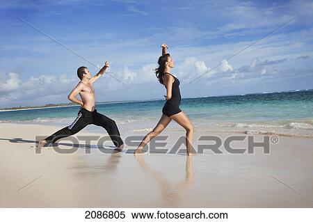 A man and woman doing yoga on the beach; punta cana la altagracia dominican republic View Large Photo Image Stock Photography - A man and woman doing yoga on the beach; punta cana la altagracia dominican republic. Fotosearch