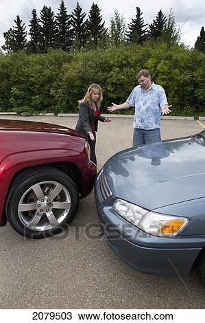 A man and woman looking at the bumpers of their vehicles after a collision; edmonton alberta canada View Large Photo Image Stock Image - A man and woman looking at the bumpers of their vehicles after a collision; edmonton alberta canada. Fotosearch