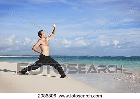 A man doing yoga on the beach; punta cana la altagracia dominican republic View Large Photo Image Stock Photograph - A man doing yoga on the beach; punta cana la altagracia dominican republic. Fotosearch