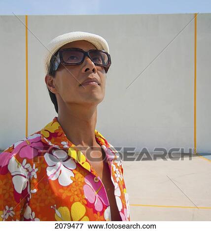 A man in a brightly coloured floral shirt in front of a wall; puerto rico View Large Photo Image Stock Photo - A man in a brightly coloured floral shirt in front of a wall; puerto rico. Fotosearch