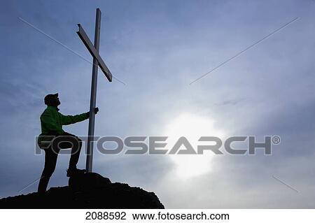 A man looks up at cross located at the top of mt. tzouhalem in the cowichan valley; british columbia canada View Large Photo Image Stock Image - A man looks up at cross located at the top of mt. tzouhalem in the cowichan valley; british columbia canada. Fotosearch