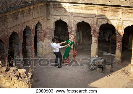 A mixed race couple dancing in a courtyard with her wearing a sari; ludhiana punjab india View Large Photo Image Stock Image - A mixed race couple dancing in a courtyard with her wearing a sari; ludhiana punjab india. Fotosearch