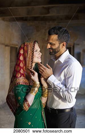 Stock Image - A mixed race couple with her wearing a sari and headscarf; ludhiana punjab india. Fotosearch