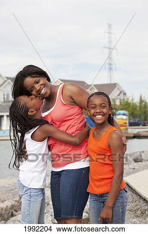 Picture - A Mother And Daughters Walking In A Residential Lake Community; Edmonton Alberta Canada. Fotosearch