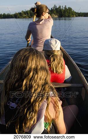 A mother and two daughters in a canoe; lake of the woods ontario canada View Large Photo Image Stock Photo - A mother and two daughters in a canoe; lake of the woods ontario canada. Fotosearch